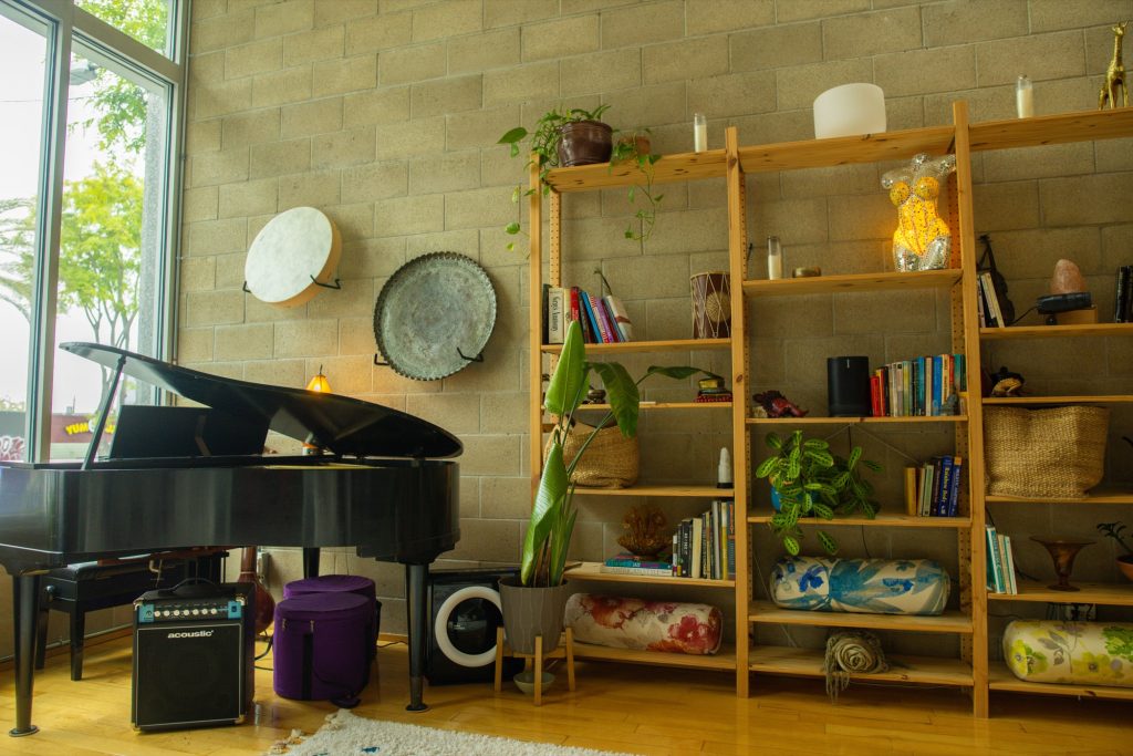 Grand piano and frame drum in golden light at the Word of Mouth Sanctuary