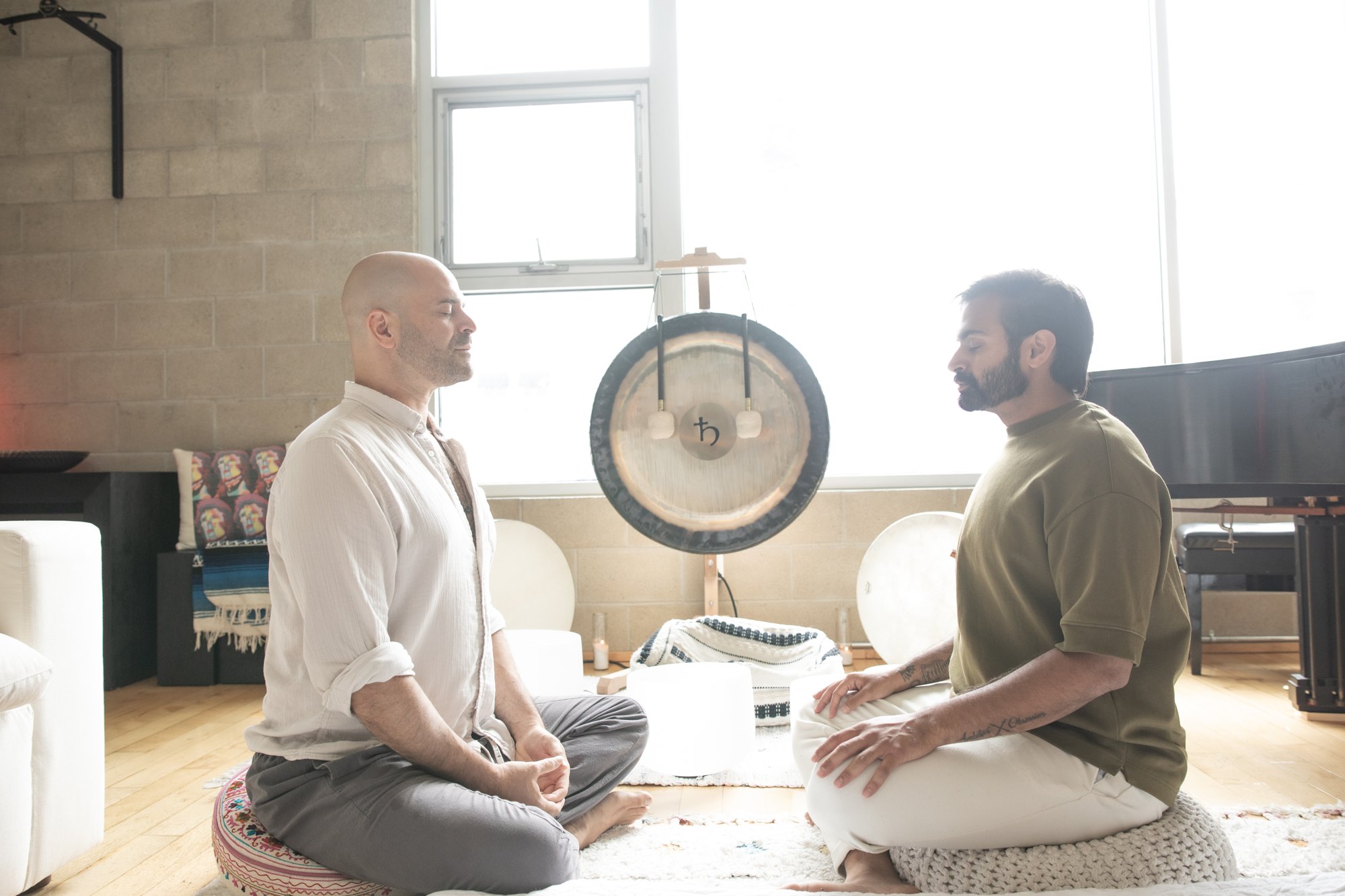 Yonatan Elkayam seated face to face with a client in front of the gong at Word of Mouth